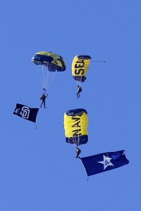 Navy SEAL Leapfrogs parachute over Petco Park with a flag in honor of former Padres announcer Jerry Coleman.